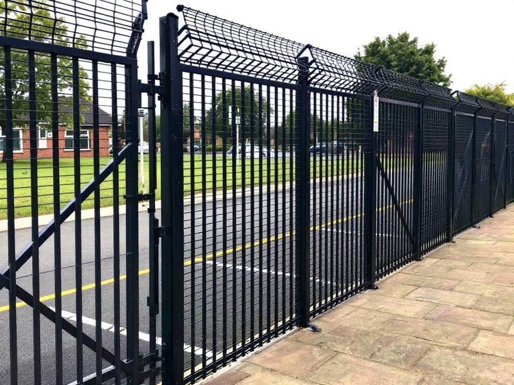 Commercial welded mesh security fence with powder coated steel panels