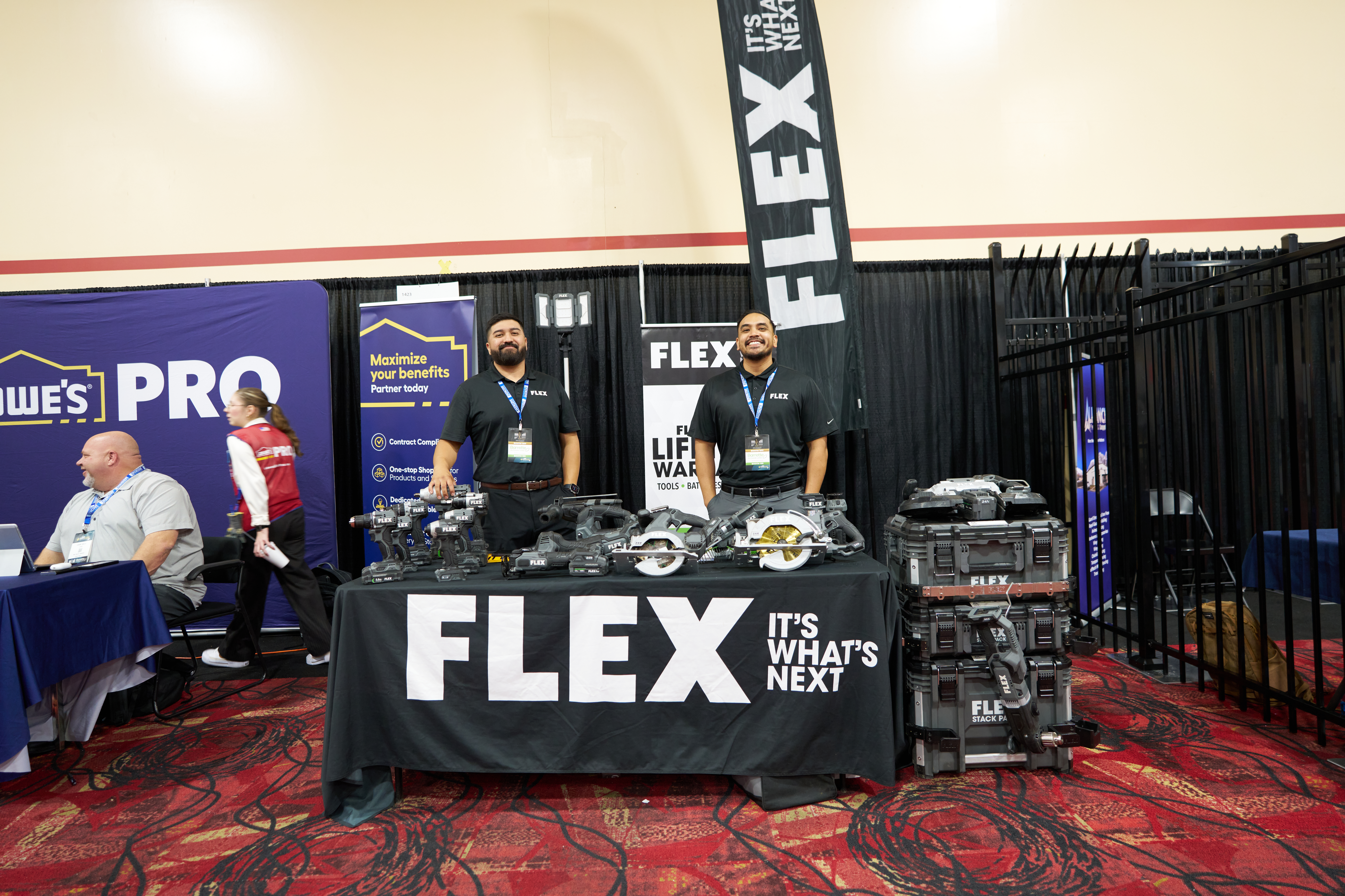 FLEX Tools trade show booth showcasing 24V cordless tools, fences, and security equipment for professional use.