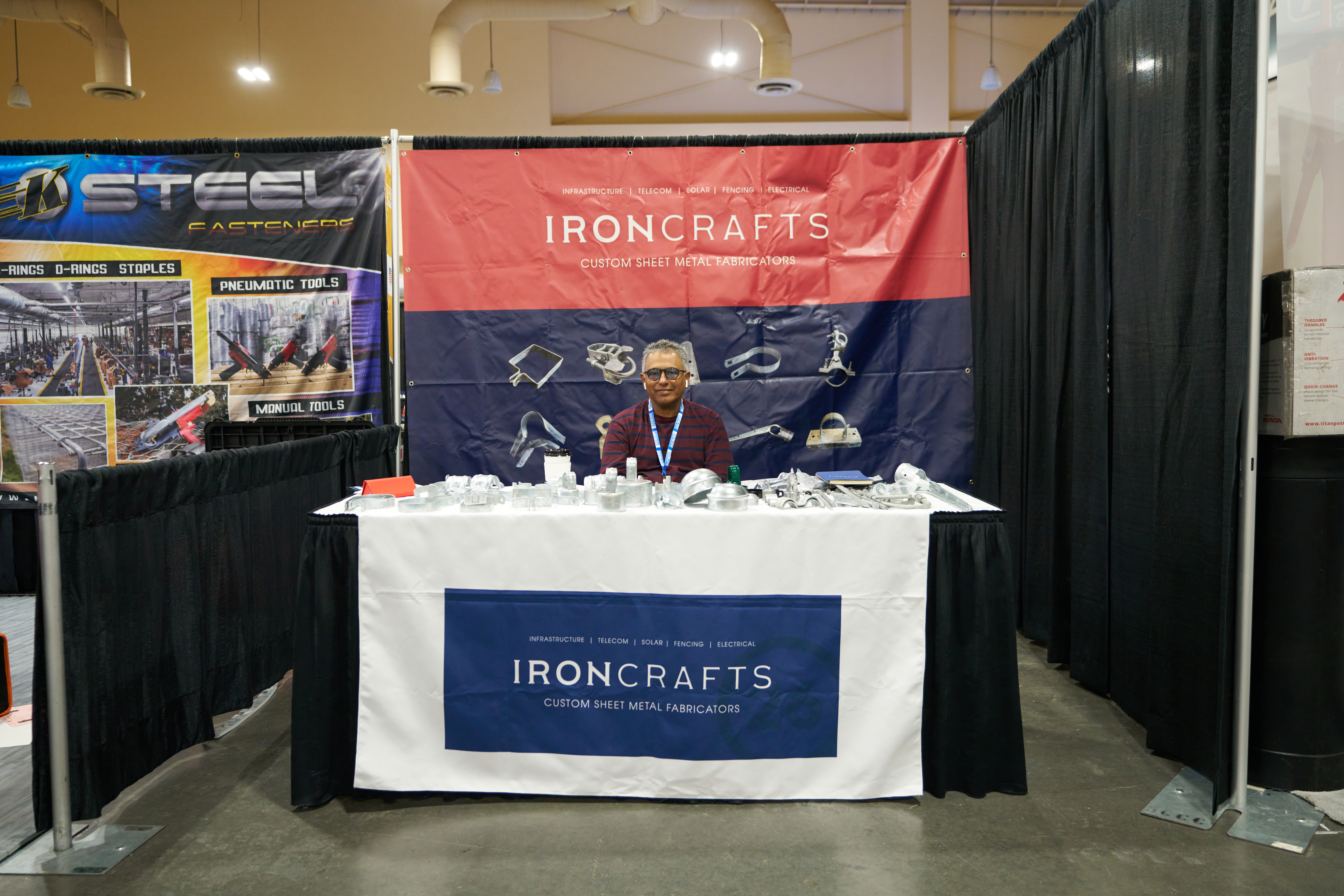 IronCrafts Inc. trade show booth showcasing custom metal fencing, gates, and security equipment for industrial applications.