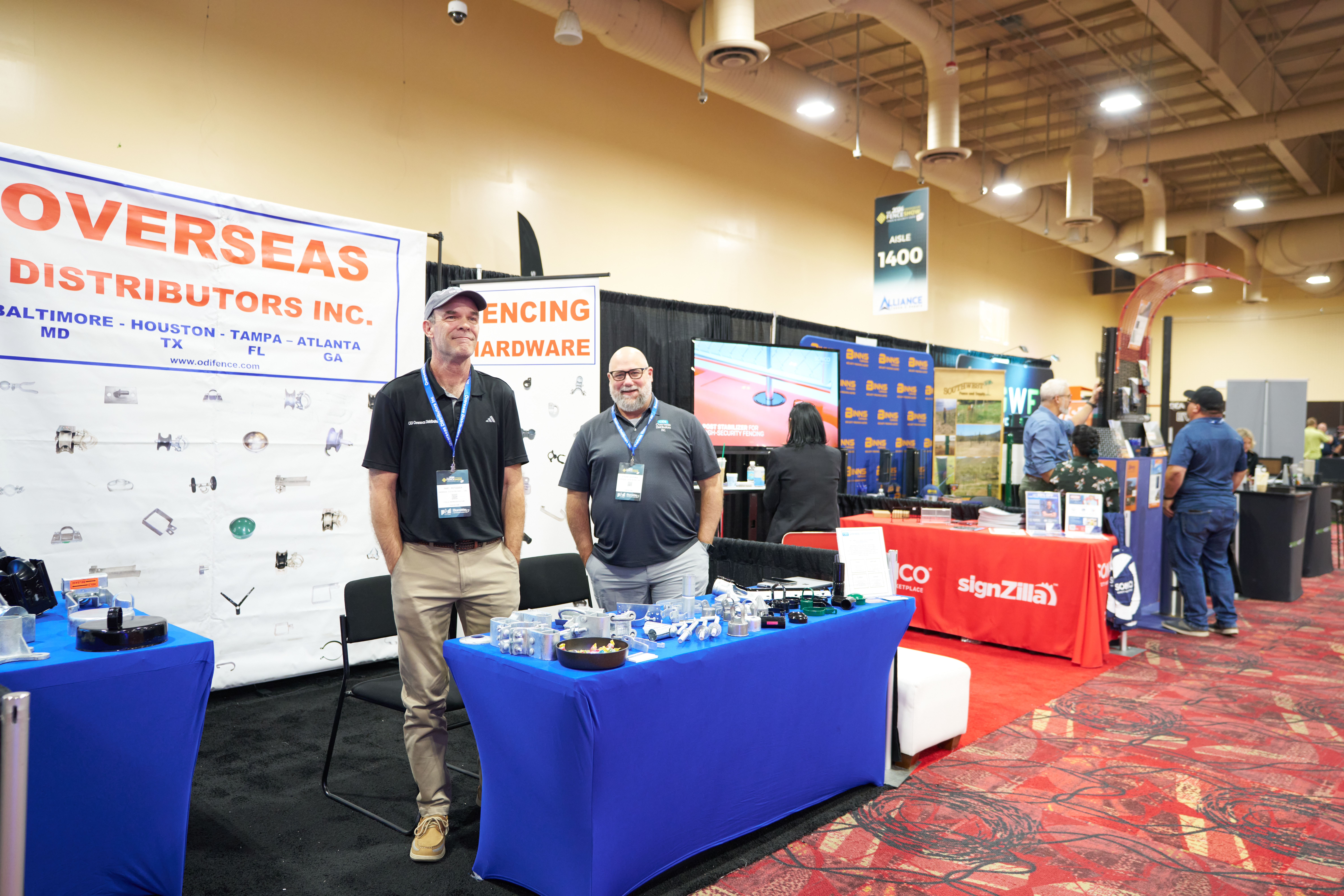 Cover image of Overseas Distributors showcasing fence products, gate hardware, and installation tools at a trade show booth.