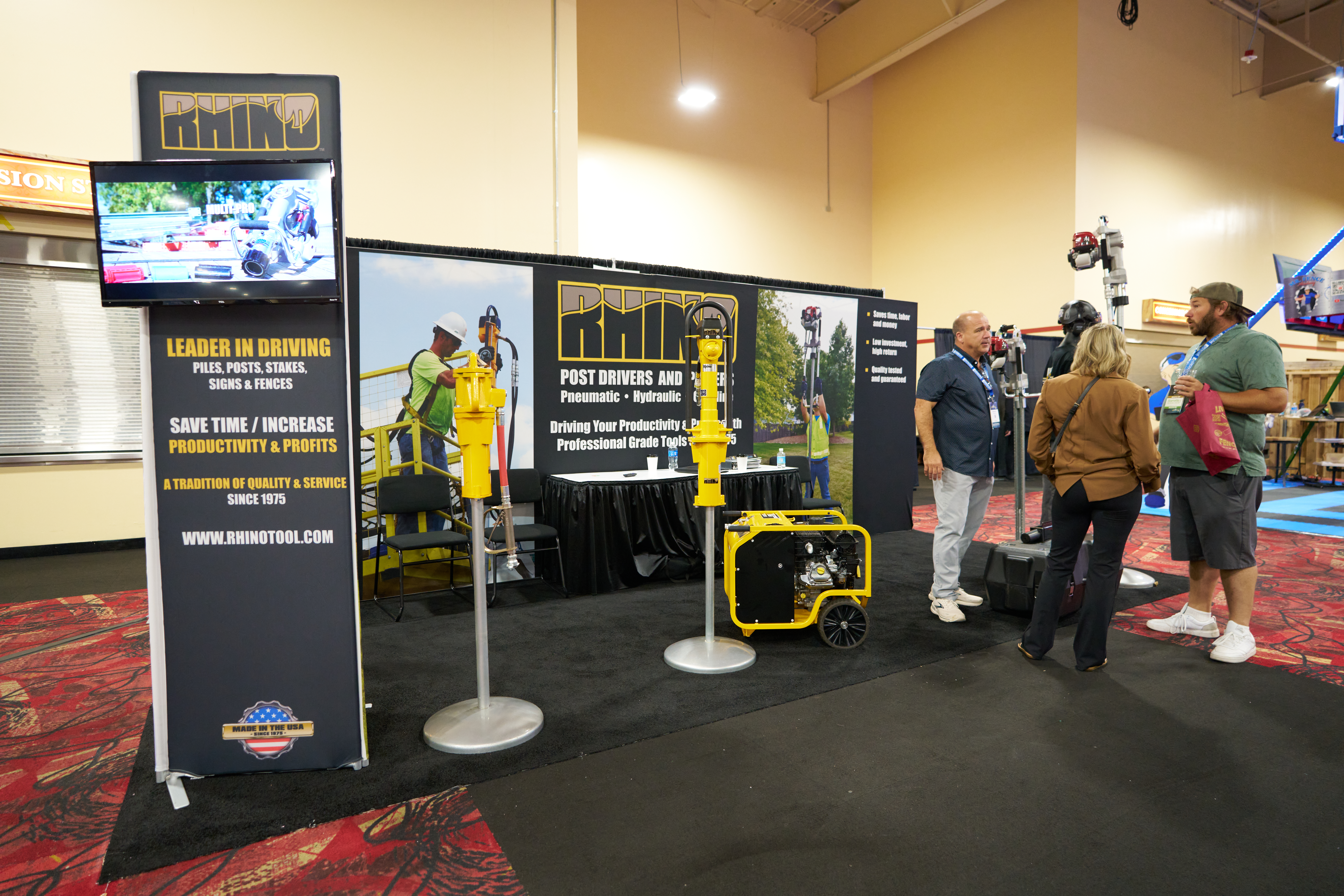 Rhino Tool Company display showcasing post drivers, fencing tools, and professional equipment at a trade show booth.