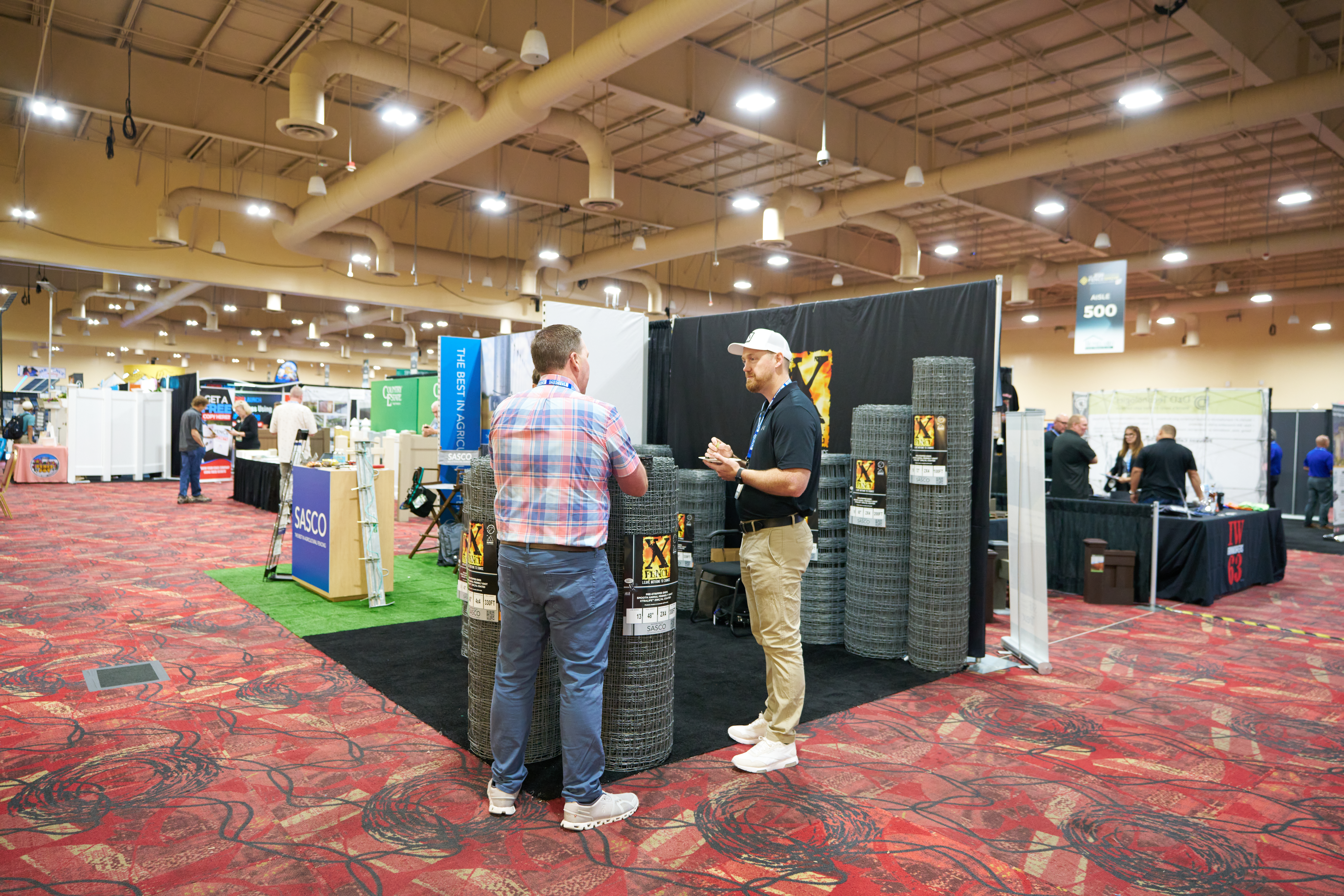 X-Fence trade show booth showcasing high-tensile fencing, gates, and security solutions for agricultural and residential use.